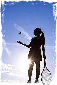 Girl silhouette about to serve in tennis